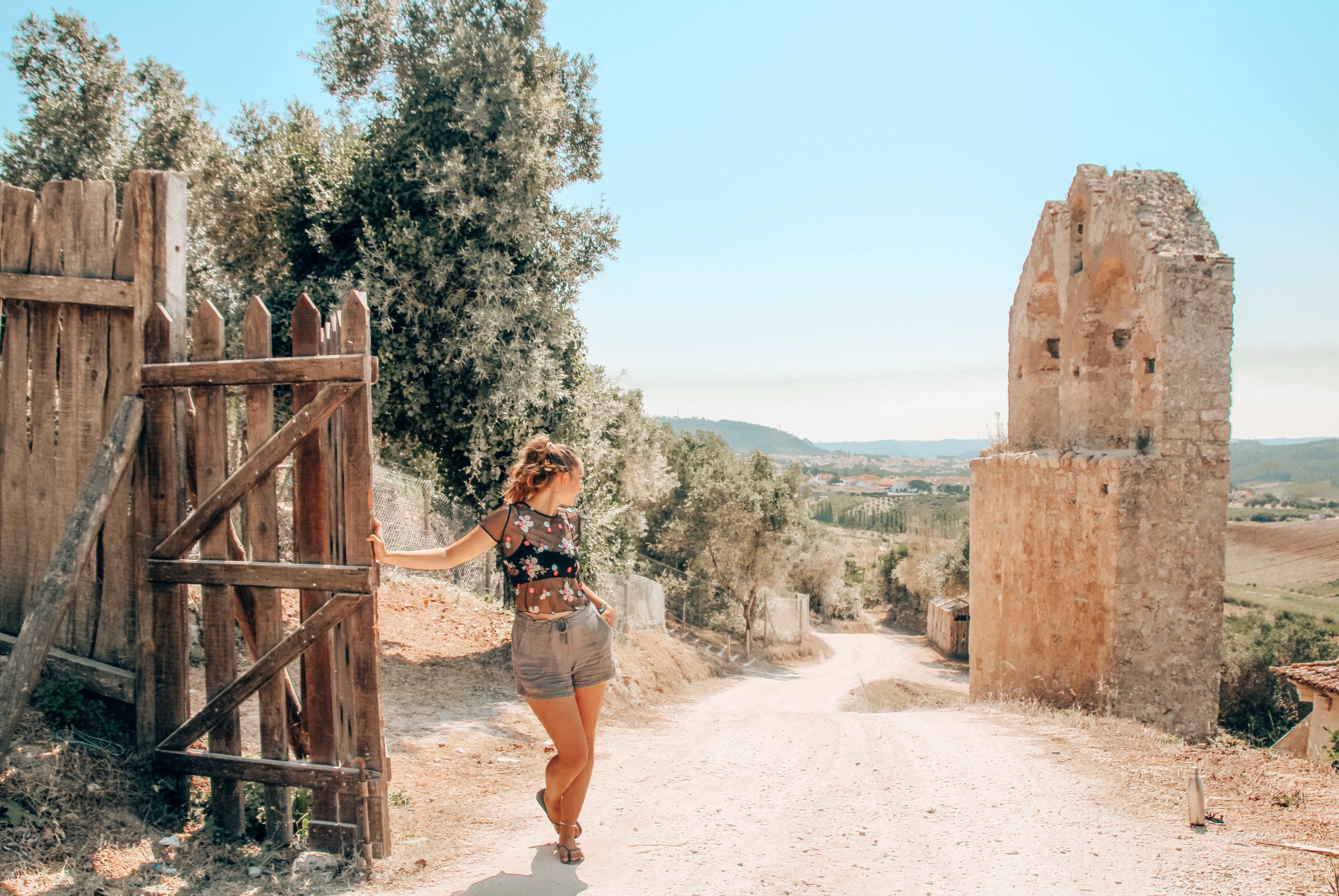 woman-rests-on-a-long-walk-through-countryside.jpg